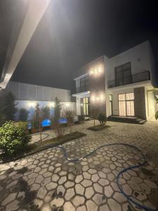 a building with a hose in front of it at Villa Mardakan in Mərdəkan