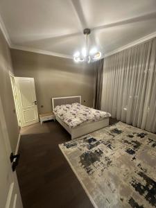 a bedroom with two beds and a chandelier at Villa Mardakan in Mərdəkan
