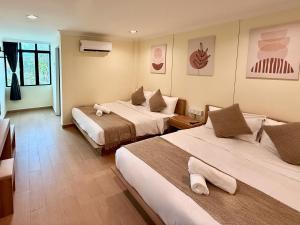 a hotel room with two beds in a room at Serene Turtle Hotel in Kuala Terengganu