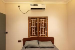 a room with a bed and a air conditioner on the wall at Sai Guest House in Chavakachcheri +19 photos