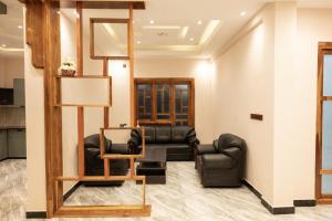 a living room with a couch and a chair at Sai Guest House in Chavakachcheri