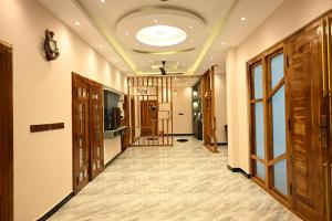 a hallway with wooden doors and a ceiling at Sai Guest House in Chavakachcheri