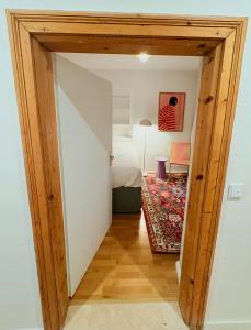 a bedroom with a bed and a room with a table at Zentrale Wohnung in Garmisch mit Zugspitzblick in Garmisch-Partenkirchen +26 photos