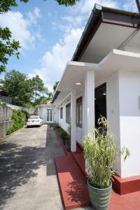 a house with a car parked in the driveway at Ora Living in Maskeliya