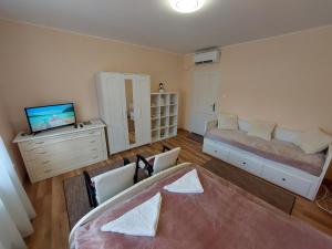 a living room with a bed and a dresser at E-Tekergők Háza in Bükkzsérc +56 photos