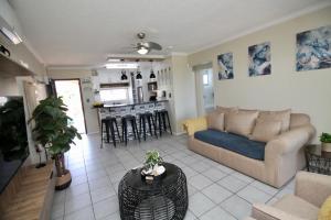 a living room with a couch and a table at Laguna La Crete 119 in Uvongo Beach