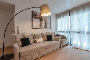 a living room with a couch and a large window at Monaco Bliss apartments 5 min to Casino in Beausoleil