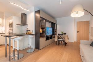 a kitchen and living room with a table and a couch at Monaco Bliss apartments 5 min to Casino in Beausoleil