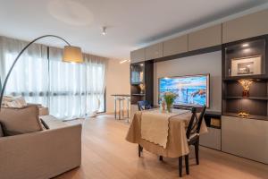 a living room with a table and a couch at Monaco Bliss apartments 5 min to Casino in Beausoleil
