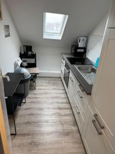a kitchen with a sink and a counter top at Monteurwohnung Krefeld WorkStay in Krefeld