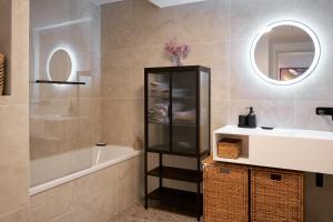 a bathroom with a tub and a sink and a mirror at Monaco Bliss apartments 5 min to Casino in Beausoleil +48 photos