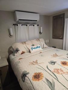 a bedroom with a bed with a flower patterned blanket at Marina View Cottage at Key Largo in Key Largo +41 photos
