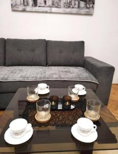 a living room with a couch and a coffee table at msapartman in Surčin