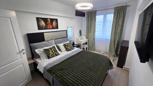 a bedroom with a large bed and a window at AVS Concept Obor in Bucharest