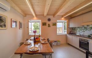 a kitchen with a large wooden table and chairs at Corte Maccarini - Appartamento Venezia - Dotato di corte interna privata in Mel