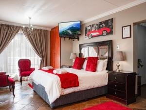 a bedroom with a bed and a red car on the wall at The Orion Guesthouse in Middelburg