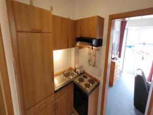 a small kitchen with a sink and a stove at Ferienanlage Orther Reede, Fehmarn-Orth in Orth