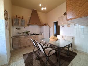 a kitchen with a table and chairs in a room at Traditional Villa Stella in Archangelos