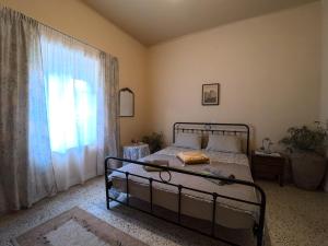 a bedroom with a bed and a large window at Traditional Villa Stella in Archangelos