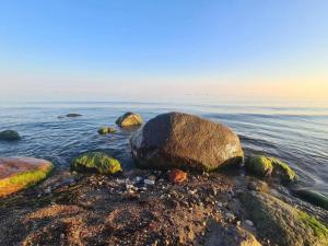 a group of large rocks in the water at Appartements Post Hiddensee in Vitte in Vitte +35 photos
