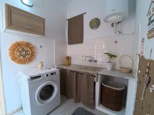 a kitchen with a washing machine and a sink at Traditional Villa Stella in Archangelos