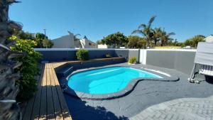 a swimming pool in a backyard with a fence at B3 bnb House in Cape Town