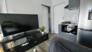 a living room with a large flat screen tv at B3 bnb House in Cape Town