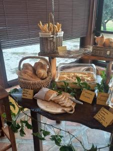 a table topped with baskets of bread and baskets of pastries at Agriturismo Il Mio Casale in Monte Colombo