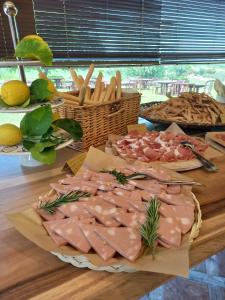 a table topped with different types of meats and cheese at Agriturismo Il Mio Casale in Monte Colombo +18 photos