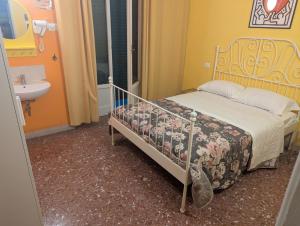 a small bedroom with a bed and a sink at pisa train station hostel in Pisa +3 photos