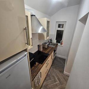 a kitchen with a sink and a counter top at Snug on Eden Derry in Londonderry County Borough