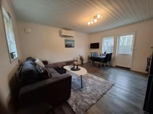 a living room with a couch and a table at Charmig stuga med havsutsikt in Karlskrona