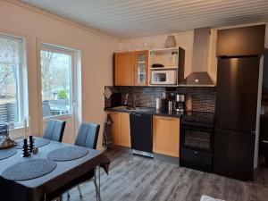 a kitchen with a table and a dining room at Charmig stuga med havsutsikt in Karlskrona