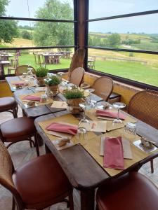 a table in a restaurant with a view of a field at Agriturismo Il Mio Casale in Monte Colombo
