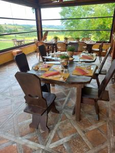 a dining room with a wooden table and chairs at Agriturismo Il Mio Casale in Monte Colombo
