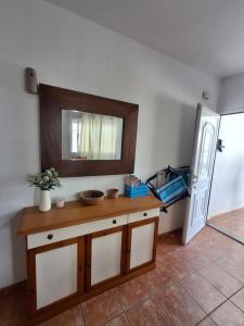 a bathroom with a counter with a mirror and a sink at Duplex Barbados Aguamarga in Agua Amarga