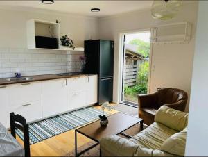 a kitchen with a refrigerator and a couch and a table at 3-Bedroom Charming Lund Home in Lund +37 photos