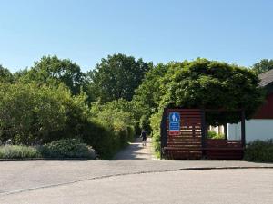 a person walking down a path next to a building at 3-Bedroom Charming Lund Home in Lund