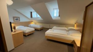 a room with two beds in a room at Hotel v Centru in České Budějovice