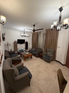 a living room with two couches and a tv at اليرموك 4 شوارع in Baghdād