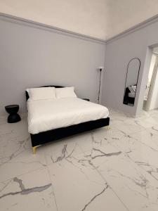 a bedroom with a bed and a marble floor at Vulcano Rooms 2 in Catania