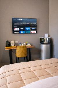 a room with a table and a kitchen with a television at Château Gombert in Marseille
