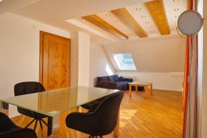 a dining room with a glass table and chairs at Villa Viktoria 3 - Apartments in Ingolstadt