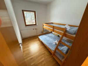 a room with two bunk beds and a window at Apartment Barbara with sauna in Gozd Martuljek