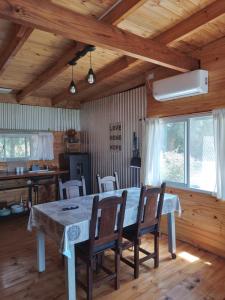 a dining room with a large table and chairs at Cabañas Campos del Parana in San Pedro