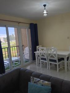 a living room with a couch and a table and chairs at Chesum's suites in Eldoret