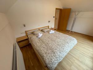 a bedroom with a bed with a teddy bear on it at Apartment Barbara with sauna in Gozd Martuljek