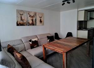 a living room with a couch and a wooden table at Golden Lion in Bouillon