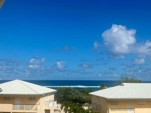 a view of the ocean from a building at L'Échappée Bleue Sea view studio in Moule in Le Moule