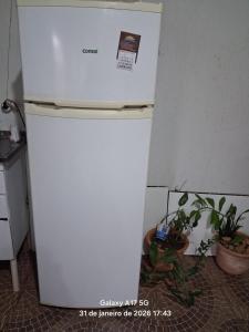 a white refrigerator in a kitchen with some plants at Vanildo Oliveira in Uberlândia